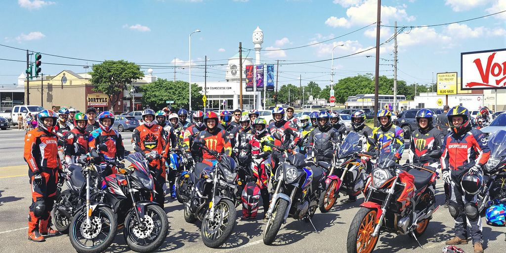 Motorcycle riders smiling with Douglasville landmarks behind them