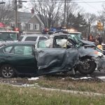 Car accident scene with emergency vehicles and tow trucks.