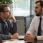 Car Accident Lawyer - Person meeting with insurance adjuster in office setting