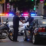 Motorcycle and car accident with people shaking hands