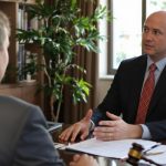 Lawyer and injured client meeting in office setting