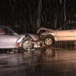Damaged cars in rainy Kennesaw street.