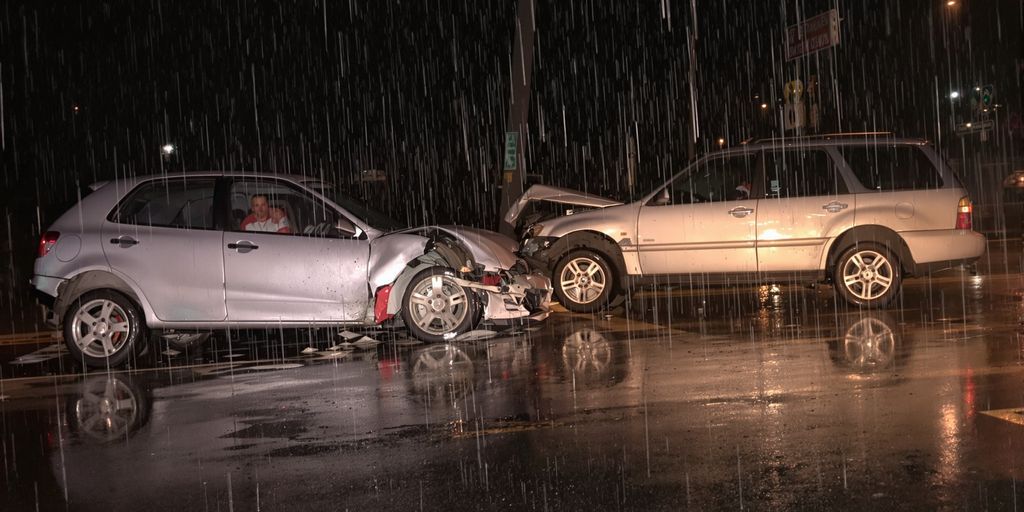 Damaged cars in rainy Kennesaw street.