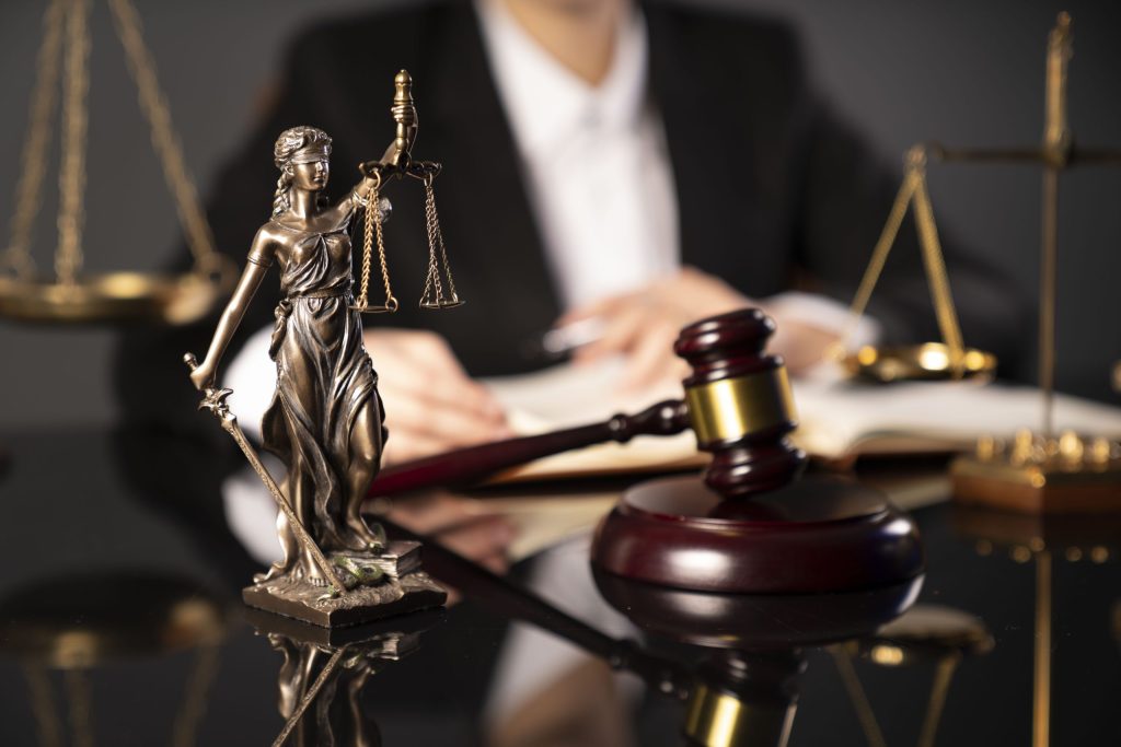 a statue of a woman with scales and gavel on a table for car accident lawyer