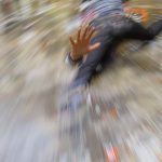 Person slipping on wet floor inside a building.