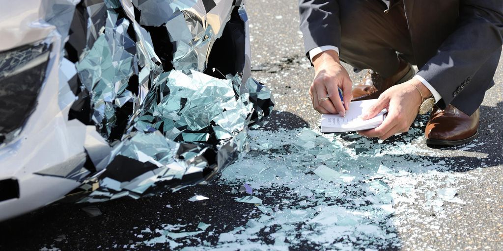 From Crash Scene to Courtroom: Singh Toro Law's Step-by-Step Injury Case Strategy 1 Lawyer examining car crash evidence.