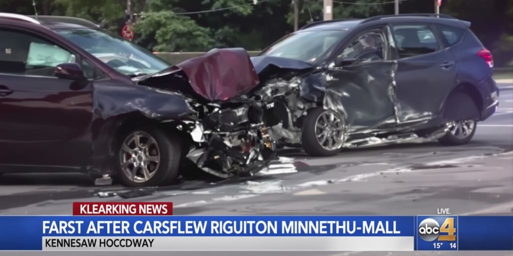 Two cars involved in a collision with a portion of a Kennesaw street visible.