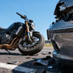 Motorcycle accident scene with damaged vehicles.