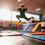 Person jumping high on a trampoline.