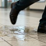 Person slipping on a wet floor.