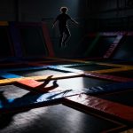 Trampoline park with a person jumping.